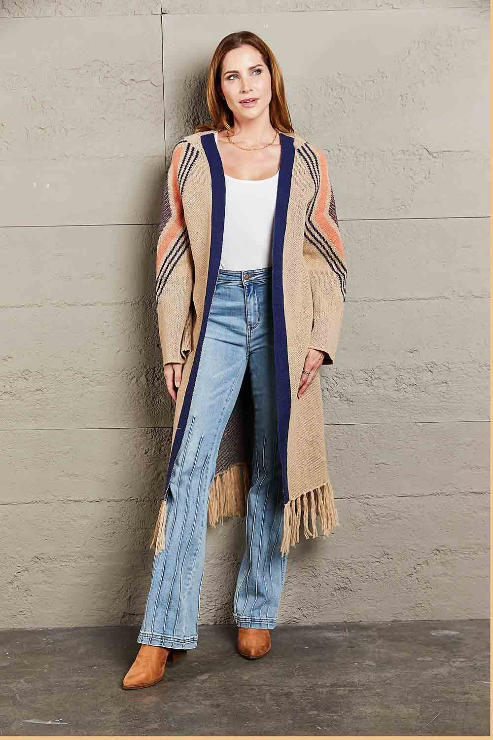 Long Fringe Cardigan- "Western Winds Boho Duster- A Layering MVP". Do you love the boho-western style? Do you love layers you can use in any season? You are in the right spot! Wrap yourself in comfort and style that feels as free as the open road. This open-front cardigan with its striking geometric accents and fringe detailing is the perfect mix of earthy charm and boho spirit. The perfect topper for every season – layer it, love it, and never look back.