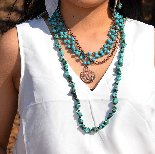 this necklace is a fantastic option. Layer this collar length necklace with longer pieces or let it stand alone. simulated turquoise chain and antique copper necklace is accented with an Indian Coin.