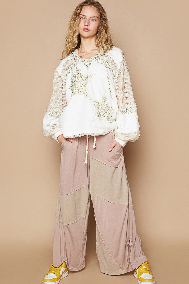 Whimsical Star Patch Hooded Shirt - A Feminine Twist on Rebel Style - Ivory Multi. Does it feel sexy to be edgy and feminine at the same time? You got it! This star print adds some whimsy, and the lace contrast gives a delicate and elegant touch to the design. We love the mixed textures, making this top perfect for both casual and dressed-up looks.