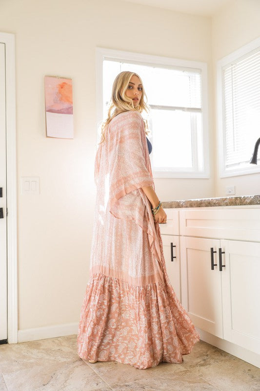 This sheer kimono is your ideal companion when you want to feel like you’re floating through life. Designed for the woman who loves to layer with ease and grace! This free flow Kimono stands out from others as it goes from a minimalist top and transitions beautifully into a rich paisley print as it flows toward the hem, creating a look that’s both modern and timeless. The oversized fit and mid-length sleeves add to the laid-back, breezy vibe, making it the ultimate piece for both lounging and living.