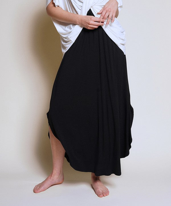 Experience ultimate comfort and effortless style with our luxurious Organic Bamboo Maxi Skirt. Crafted from a dreamy blend of organic bamboo and soft, stretchy spandex, this skirt offers an incredible drape and moves with you, offering a flattering fit that feels as good as it looks. The smocked elastic waist hugs gently, giving you all-day ease, while the flowing silhouette adds a graceful, boho touch to any outfit. This is a savvy choice for those who are eco-friendly or have skin conditions.