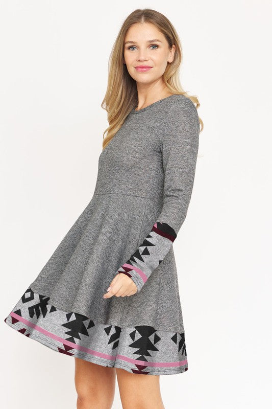 Layered Fit and Flare Dress- "Flatter Every Curve, Own Every Moment!. This dress transition easily between settings, from office to party attire, with the right accessories! Pair with your favorite boots. This flared dress is both cozy and chic. Aztec trim.