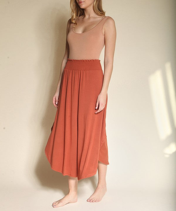 Experience ultimate comfort and effortless style with our luxurious Organic Bamboo Maxi Skirt. Crafted from a dreamy blend of organic bamboo and soft, stretchy spandex, this skirt offers an incredible drape and moves with you, offering a flattering fit that feels as good as it looks. The smocked elastic waist hugs gently, giving you all-day ease, while the flowing silhouette adds a graceful, boho touch to any outfit. This is a savvy choice for those who are eco-friendly or have skin conditions.