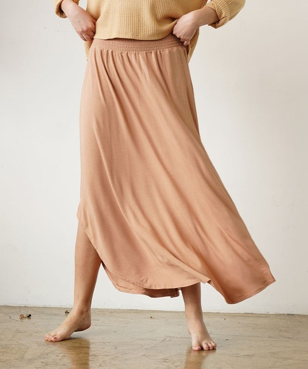Experience ultimate comfort and effortless style with our luxurious Organic Bamboo Maxi Skirt. Crafted from a dreamy blend of organic bamboo and soft, stretchy spandex, this skirt offers an incredible drape and moves with you, offering a flattering fit that feels as good as it looks. The smocked elastic waist hugs gently, giving you all-day ease, while the flowing silhouette adds a graceful, boho touch to any outfit. This is a savvy choice for those who are eco-friendly or have skin conditions.