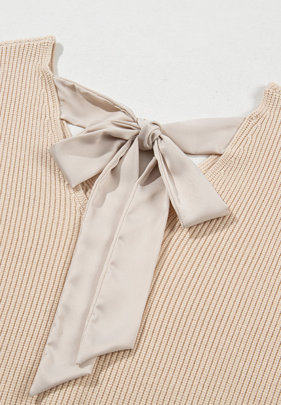 Thick and comfy feminine V-neck sweater. You can choose between (or get both) two gorgeous colors: a creamy beige and a hunter dark green. What else make's this long sleeve different? The feminine tied back bow! This long sleeve sweater can be casual and carefree during the day and dressed up at night. Enjoy the bit of sexy edginess!
