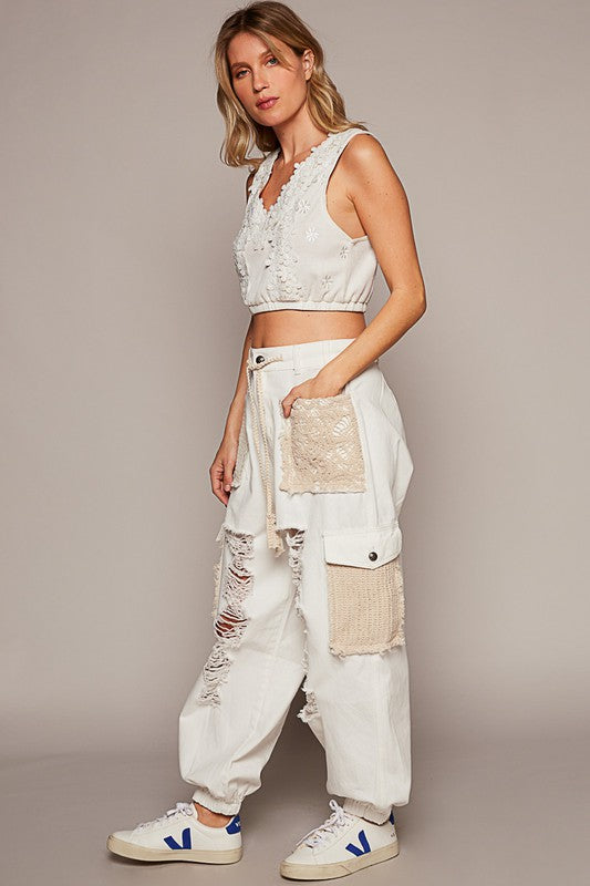 If you prefer a distinct touch to what you wear and you love the blend of feminine with a bit of edge, then these jogger jeans are meant for you! These distressed washed jeans feature a unique combination of crochet detailing and distressed elements, creating an eclectic touch to your wardrobe. Picture the ideal free-spirted look of a delicate and feminine contrast to the rugged distressed areas. These jeans are versatile and can be dressed up with a blouse and heels or dressed down with a casual t-shirt