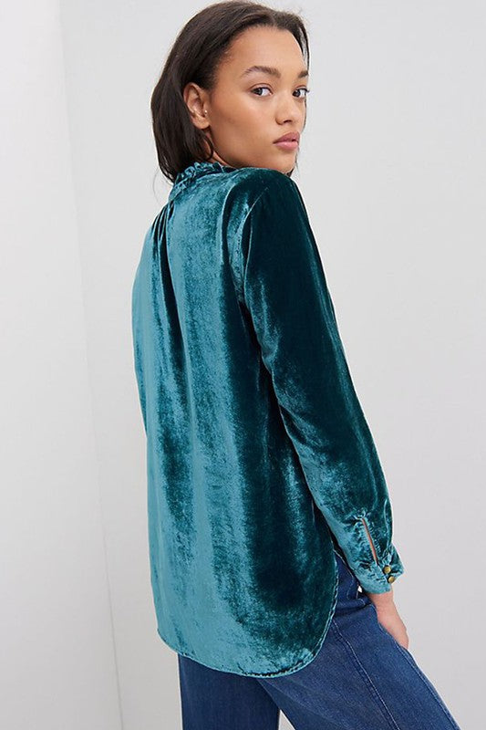 This luxurious velvet blouse is soft, skin-friendly, and lightweight, offering both comfort and elegance. Featuring a classic V-neck, button design, and feminine frilled neckline, it adds a timeless touch to your wardrobe. Perfectly paired with jeans, leggings, skirts, or boots, this versatile top is ideal for any occasion—whether casual, office, or a night out.. Several stunning colors available. All you need to do is pick!