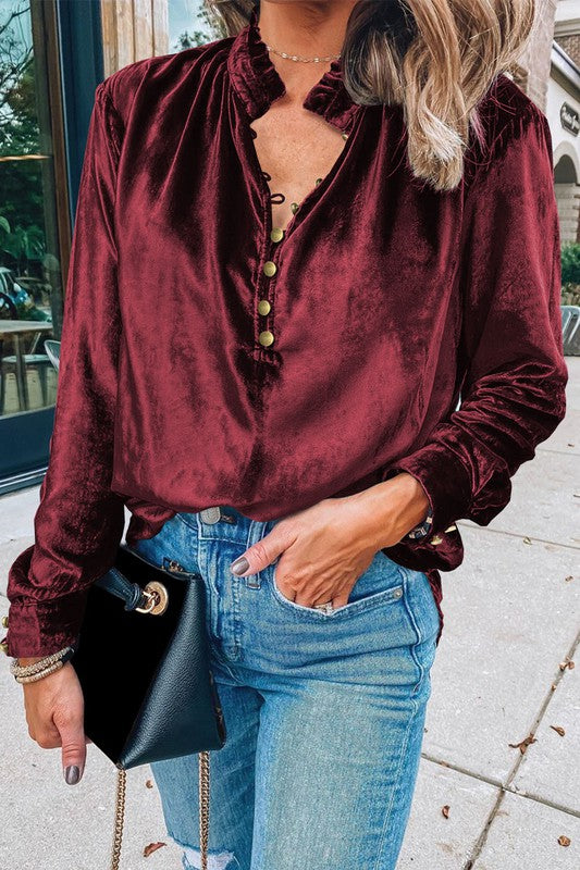 This luxurious velvet blouse is soft, skin-friendly, and lightweight, offering both comfort and elegance. Featuring a classic V-neck, button design, and feminine frilled neckline, it adds a timeless touch to your wardrobe. Perfectly paired with jeans, leggings, skirts, or boots, this versatile top is ideal for any occasion—whether casual, office, or a night out.. Several stunning colors available. All you need to do is pick!