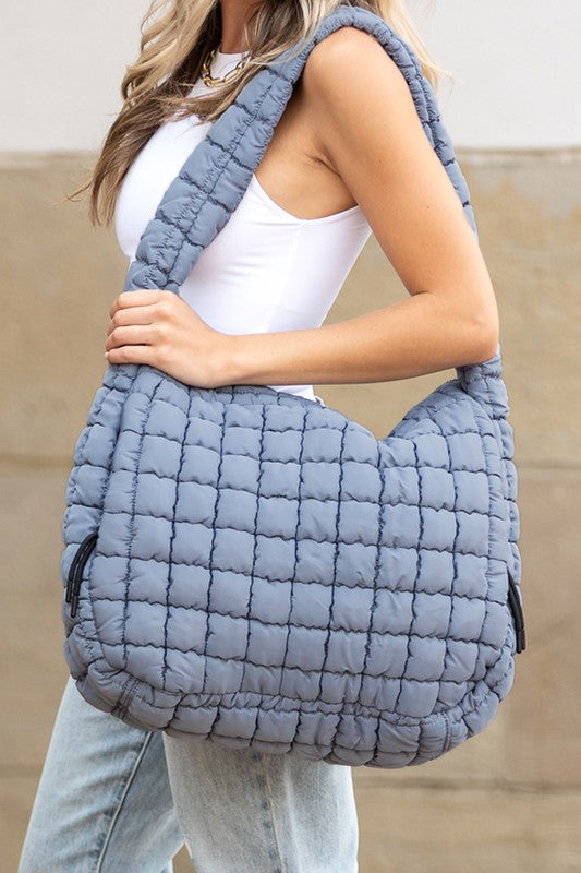 Quilted Puffer Tote- The Prairie Puff. Discover the quilted handbag your outfits need! Imagine the timeless elegance of a quilted crossbody bag that’s designed to blend sophistication, functionality, and everyday practicality. It is an iconic accessory that is more than just a bag—it’s a statement piece that aligns with your style while meeting your daily needs. The raised quilted pattern adds depth, texture, and visual interest to the bag, making it more eye-catching and unique!
