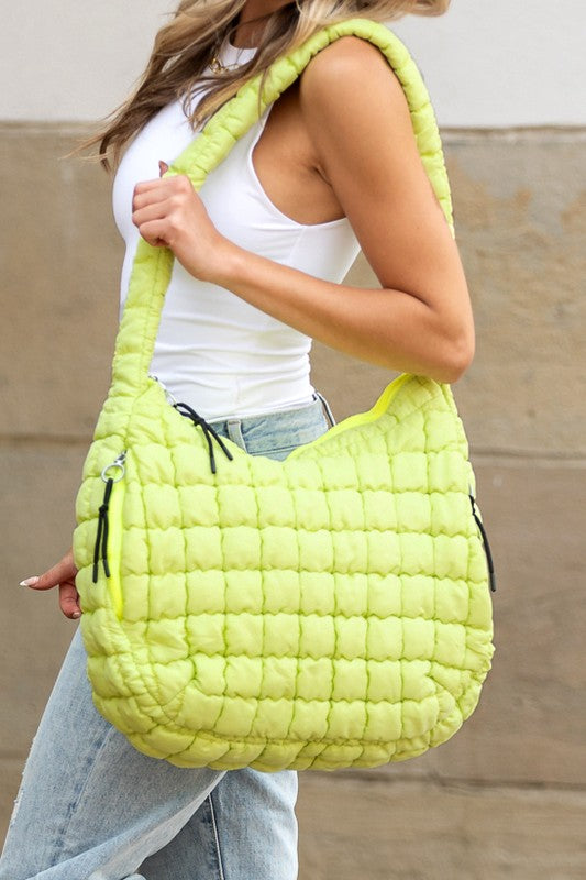 Quilted Puffer Tote- The Prairie Puff. Discover the quilted handbag your outfits need! Imagine the timeless elegance of a quilted crossbody bag that’s designed to blend sophistication, functionality, and everyday practicality. It is an iconic accessory that is more than just a bag—it’s a statement piece that aligns with your style while meeting your daily needs. The raised quilted pattern adds depth, texture, and visual interest to the bag, making it more eye-catching and unique!
