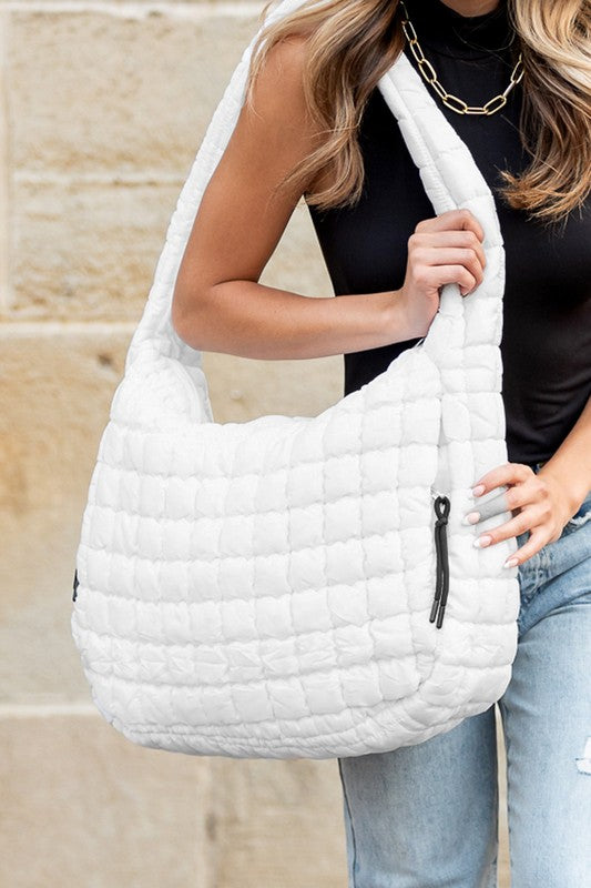 Quilted Puffer Tote- The Prairie Puff. Discover the quilted handbag your outfits need! Imagine the timeless elegance of a quilted crossbody bag that’s designed to blend sophistication, functionality, and everyday practicality. It is an iconic accessory that is more than just a bag—it’s a statement piece that aligns with your style while meeting your daily needs. The raised quilted pattern adds depth, texture, and visual interest to the bag, making it more eye-catching and unique!