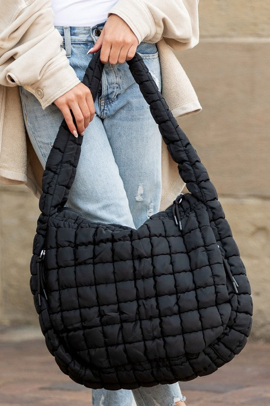 Quilted Puffer Tote- The Prairie Puff. Discover the quilted handbag your outfits need! Imagine the timeless elegance of a quilted crossbody bag that’s designed to blend sophistication, functionality, and everyday practicality. It is an iconic accessory that is more than just a bag—it’s a statement piece that aligns with your style while meeting your daily needs. The raised quilted pattern adds depth, texture, and visual interest to the bag, making it more eye-catching and unique!