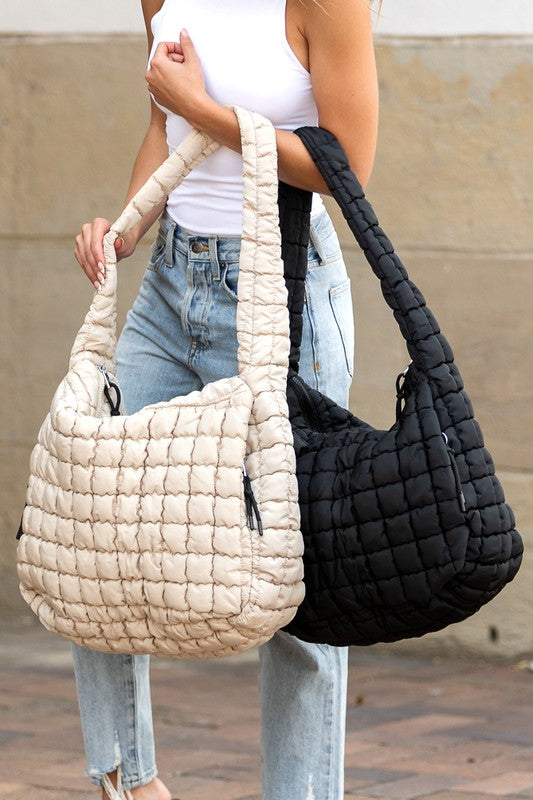 Quilted Puffer Tote- The Prairie Puff. Discover the quilted handbag your outfits need! Imagine the timeless elegance of a quilted crossbody bag that’s designed to blend sophistication, functionality, and everyday practicality. It is an iconic accessory that is more than just a bag—it’s a statement piece that aligns with your style while meeting your daily needs. The raised quilted pattern adds depth, texture, and visual interest to the bag, making it more eye-catching and unique!