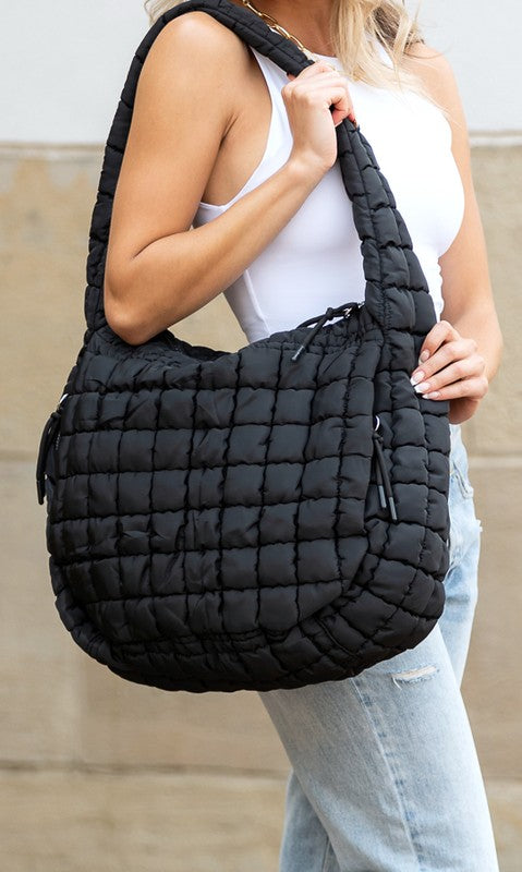 Quilted Puffer Tote- The Prairie Puff. Discover the quilted handbag your outfits need! Imagine the timeless elegance of a quilted crossbody bag that’s designed to blend sophistication, functionality, and everyday practicality. It is an iconic accessory that is more than just a bag—it’s a statement piece that aligns with your style while meeting your daily needs. The raised quilted pattern adds depth, texture, and visual interest to the bag, making it more eye-catching and unique!