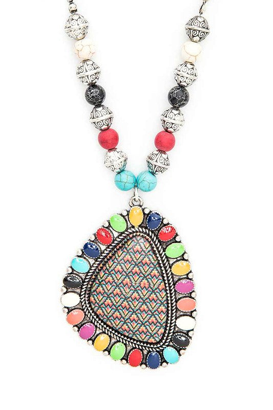 There’s something about a bold pendant that feels like a secret. The kind that’s just waiting to be discovered—maybe on a late-night stroll under the stars, or at that quirky café you've been meaning to try. The Aztec Printed Large Pendant Necklace, with its 24" chain, carries the spirit of adventure. It's the necklace you wear when you're ready to break free from the ordinary and step into something a little more you.