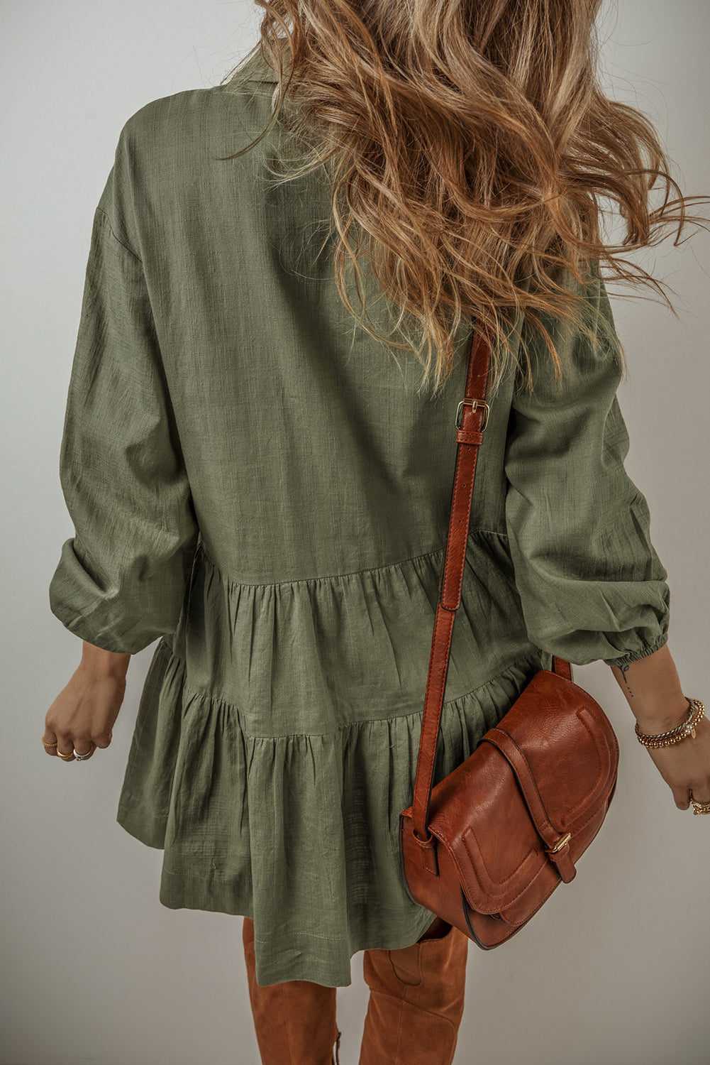 Feel the way this dress moves, (loose and flowy) and you will feel ready to start your day! The tiered style and army green creates a flattering dress that is equal parts free-spirited and laid-back western. The textured ruching along the seams creates a subtle, rippling effect that adds a touch of character to the flowy silhouette. Balloon sleeves bring a playful, whimsical vibe. Designed for comfort and breathability, this dress is perfect for those sunny afternoons or casual get-togethers.