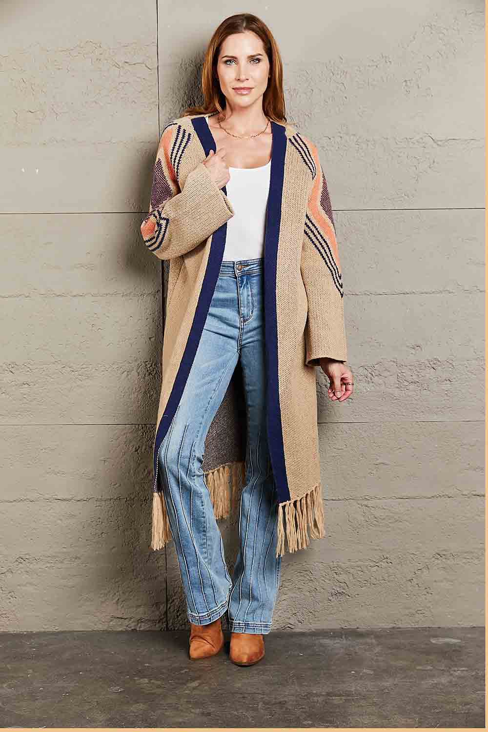 Long Fringe Cardigan- "Western Winds Boho Duster- A Layering MVP". Do you love the boho-western style? Do you love layers you can use in any season? You are in the right spot! Wrap yourself in comfort and style that feels as free as the open road. This open-front cardigan with its striking geometric accents and fringe detailing is the perfect mix of earthy charm and boho spirit. The perfect topper for every season – layer it, love it, and never look back.