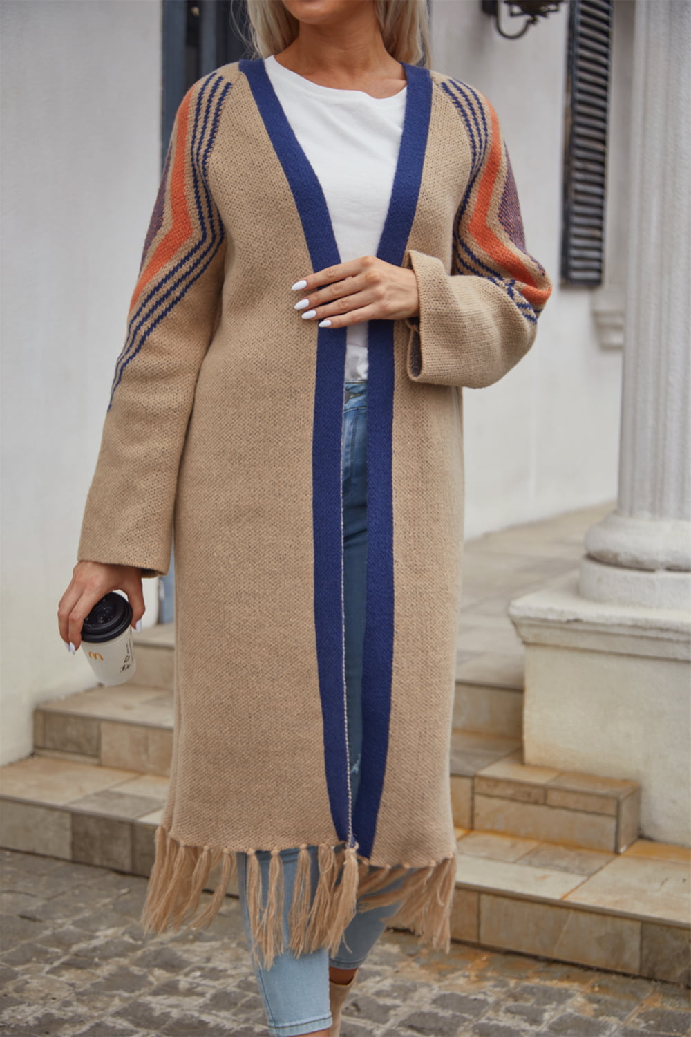 Long Fringe Cardigan- "Western Winds Boho Duster- A Layering MVP". Do you love the boho-western style? Do you love layers you can use in any season? You are in the right spot! Wrap yourself in comfort and style that feels as free as the open road. This open-front cardigan with its striking geometric accents and fringe detailing is the perfect mix of earthy charm and boho spirit. The perfect topper for every season – layer it, love it, and never look back.
