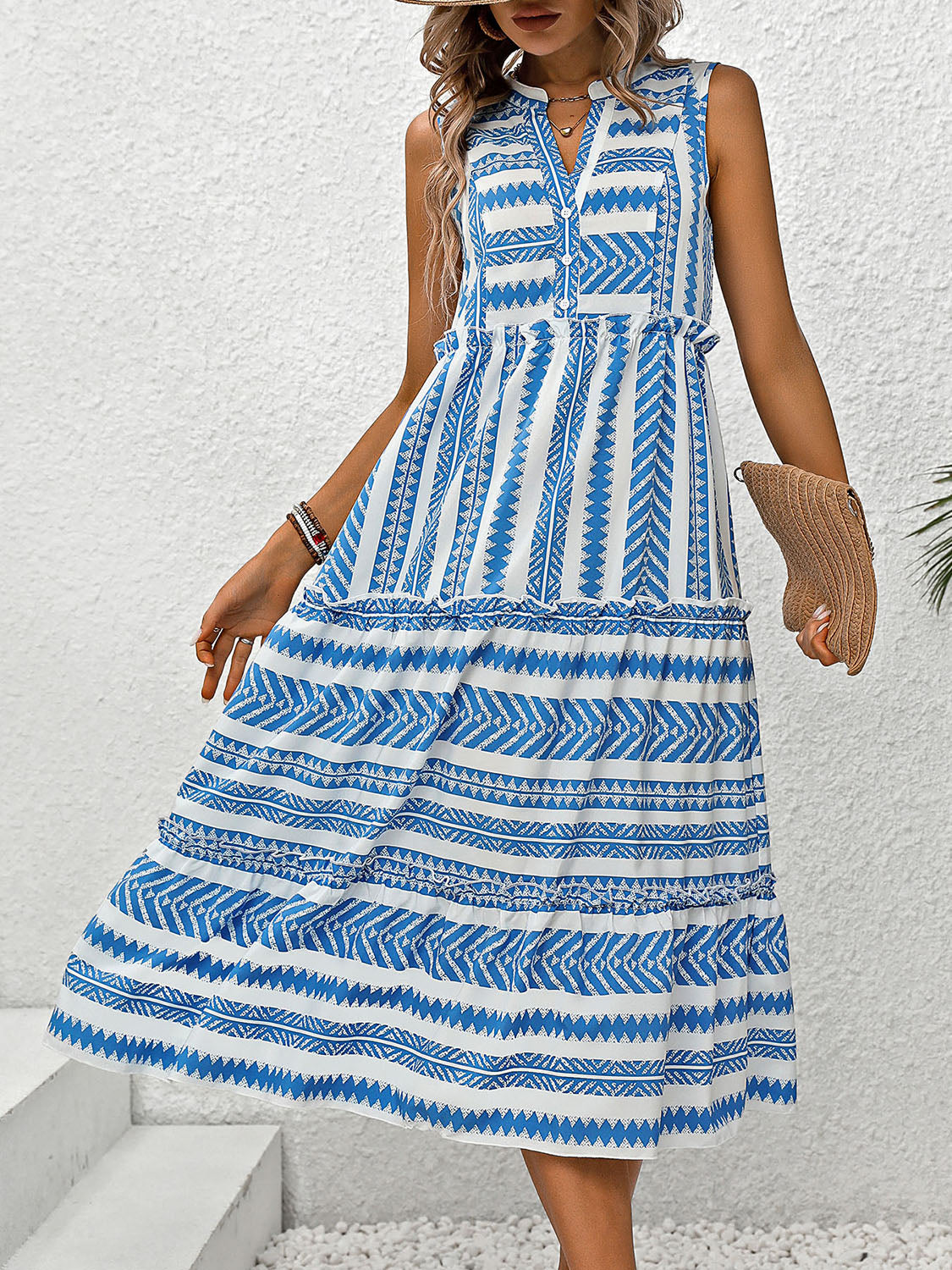 Notched Sleeveless Dress. Are you going somewhere warm and sunny this winter? Need a vacation dress? This dress has a fun design, some frill, is flowy and breathable. Imagine walking down the beach, checking out the attractions, or sipping on your favorite drink at the outdoor bar in this "vacay" dress.