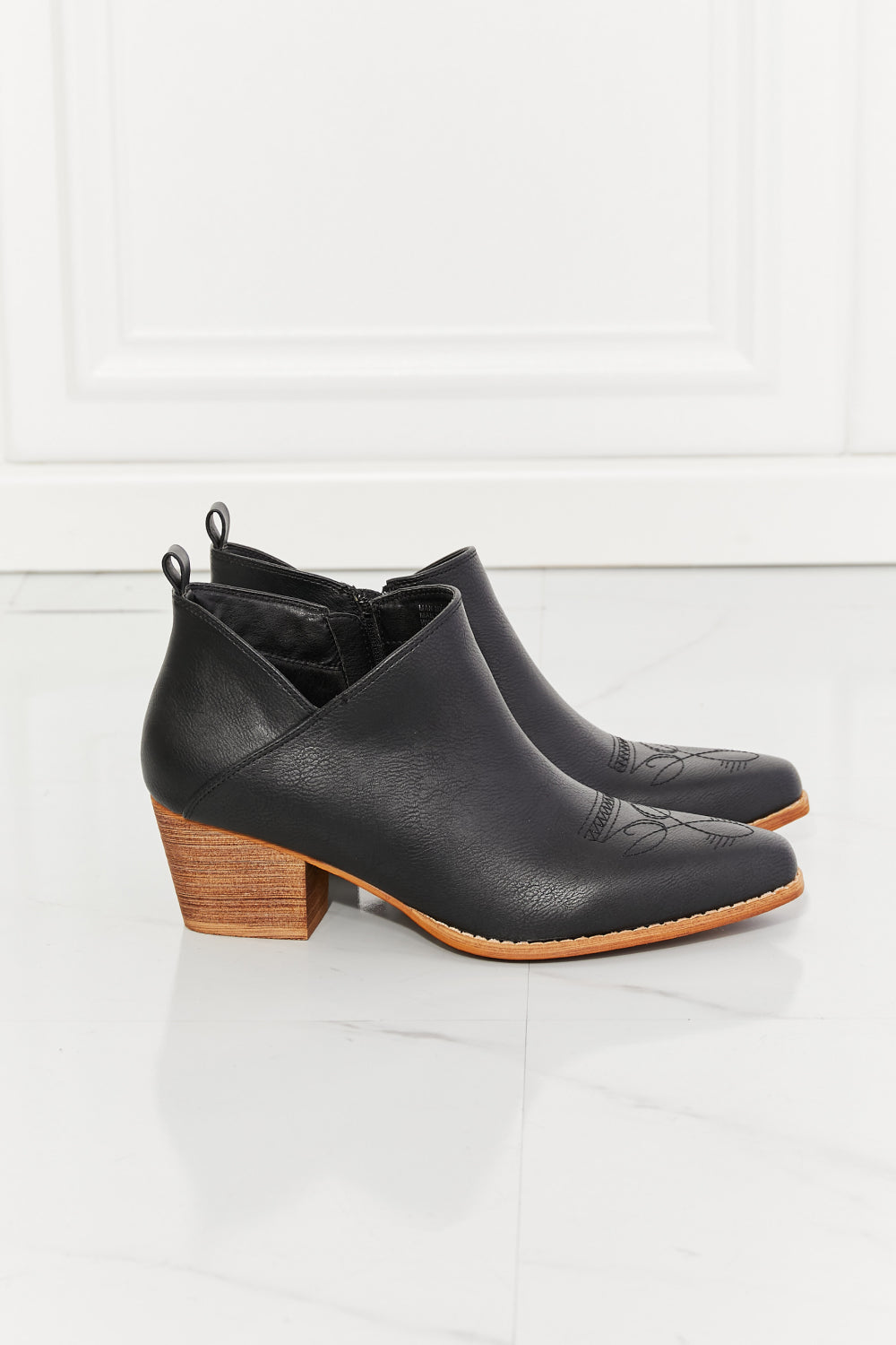 We've fallen in love with these crossover cowboy booties, with 2.5-inch stacked heel in black. These stunning crossover cowboy booties are designed to deliver both style and comfort. They feature a pointed toe, bold stitching, and a block heel for effortless all-day wear. They transition well from season to season. The embroidered design provides a classic touch and these cowboy booties pair well with distressed jeans or your favorite dresses.