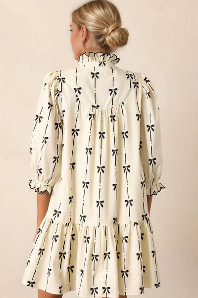 This half sleeve mini dress with flirty ruffles at your neck and cuffs is feminine, flowy, and romantic! The bow print adds another distinct charm to this tiered mini dress.