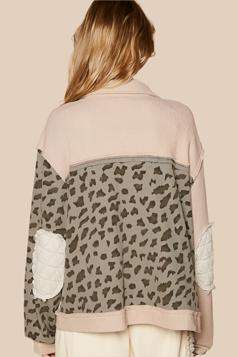 The Leopard, Button Up Quilted Jacket offers creative individual style. This unique design has several features that make it different from your average jacket: quilted and waffle fabrics, elbow patches, exposed seams, a mix of creams, ivory, and leopard prints.
