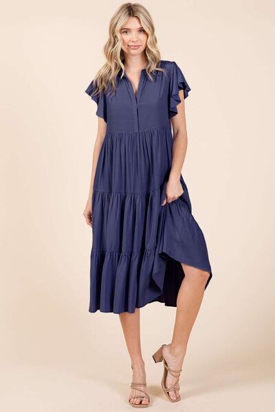 A ruffle sleeve, collared V-neck, tiered midi dress provides a simple feminine style. The tiered design creates a layered and textured look, adding dimension and flow. The midi length falls below the knee, making it versatile for both casual and more dressed-up occasions. Whether you're enjoying a sunny day in the park or headed to a rooftop dinner, this dress pairs effortlessly with sandals, boots, or layered jewelry for a carefree yet stylish vibe.