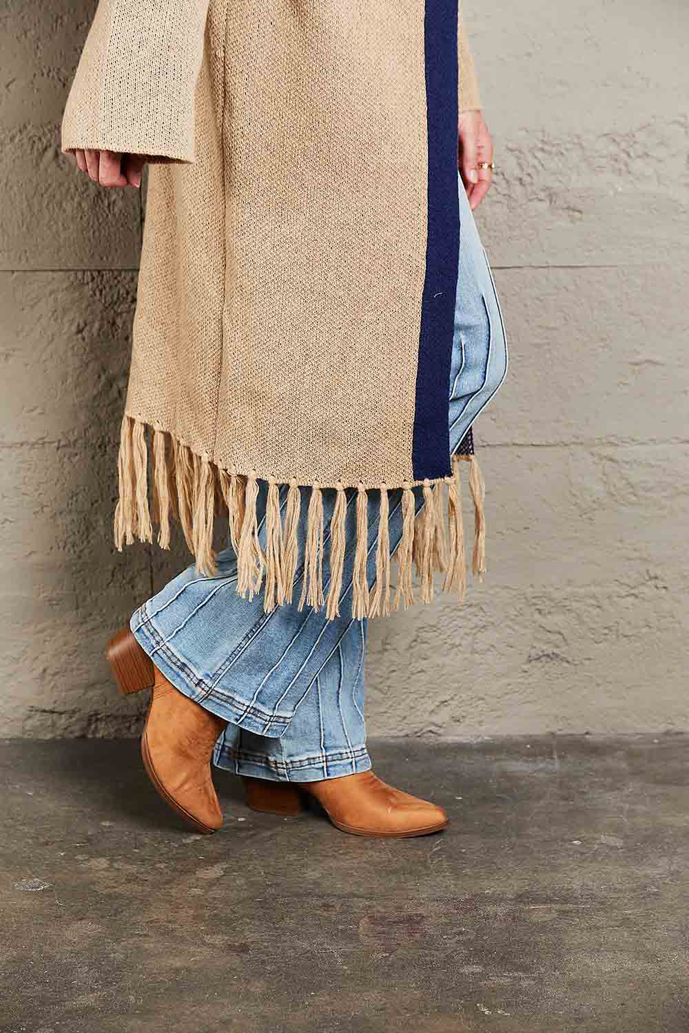 Long Fringe Cardigan- "Western Winds Boho Duster- A Layering MVP". Do you love the boho-western style? Do you love layers you can use in any season? You are in the right spot! Wrap yourself in comfort and style that feels as free as the open road. This open-front cardigan with its striking geometric accents and fringe detailing is the perfect mix of earthy charm and boho spirit. The perfect topper for every season – layer it, love it, and never look back.