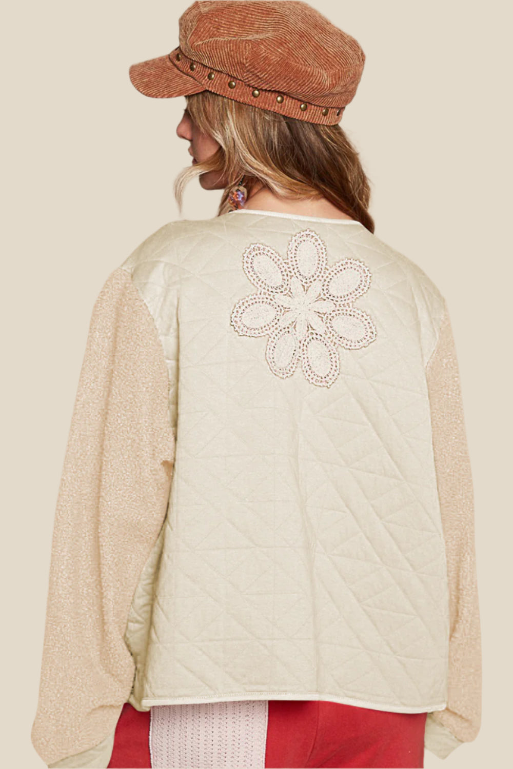 Imagine slipping into a quilted top with crochet appliques and furry sleeves – it’s like wrapping yourself in a cozy, stylish hug. The textured fabric feels warm and soft, perfect for those chill days when you just want to be comfortable but still look effortlessly chic. With the delicate crochet details, you can feel like a work of art, while the furry sleeves add that playful, free-spirited touch – it’s like you’re wearing a piece of whimsy.