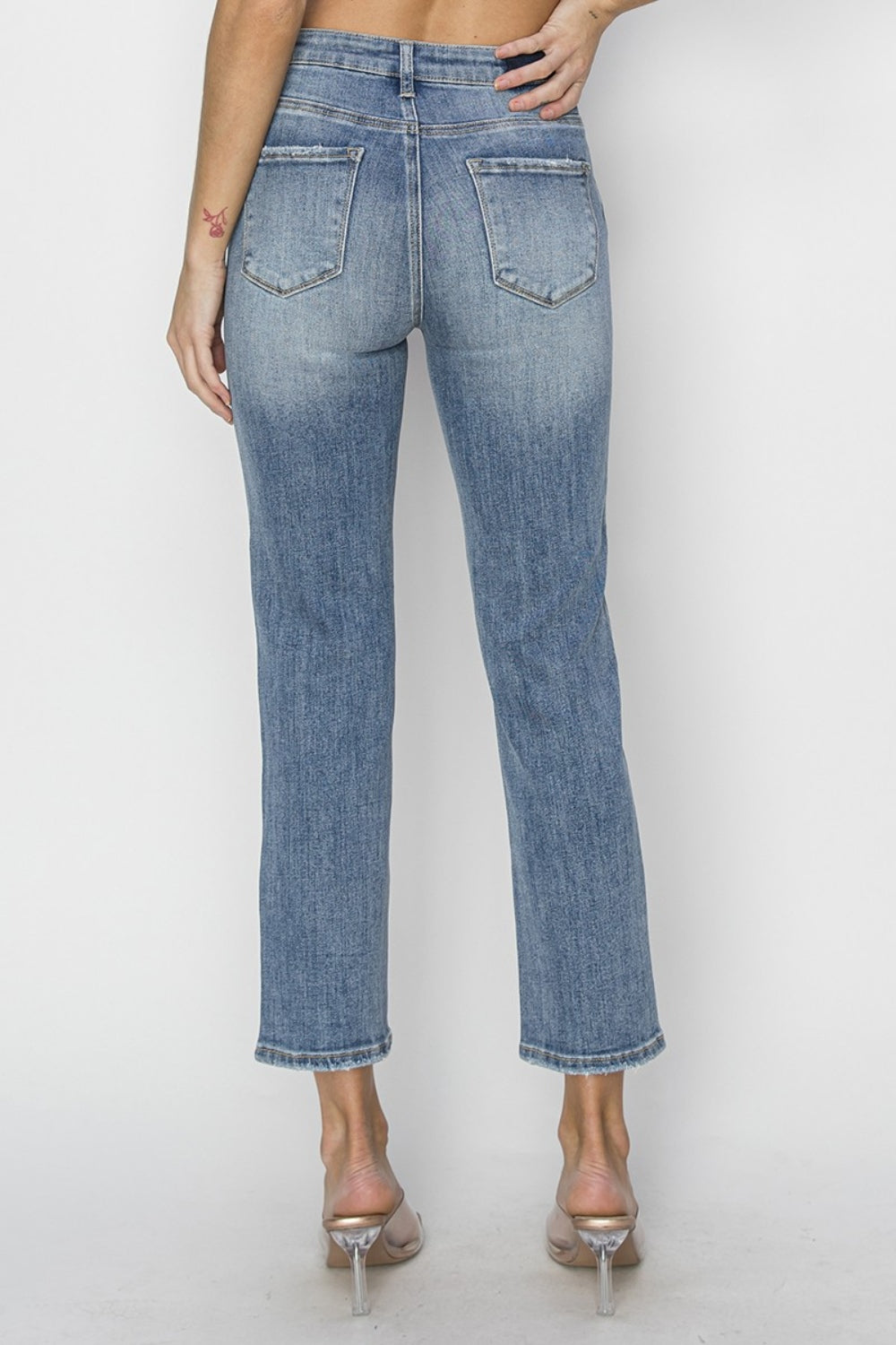 RISEN High Waist Distressed Cropped Jeans- Your Boho Canvas. These are the perfect jeans to express your individuality and your free-spirited creativity! Dive in to curating your unique bohemian look and celebrate self-expression with these jeans as your canvas! medium wash.