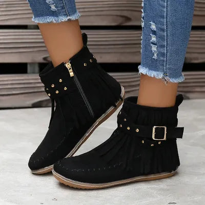 Step into the spirit of adventure with these Fringe Studded Suede Flat Boots. Designed for the free-spirited woman who craves comfort and style, these boots blend western ruggedness and bohemian flair. With soft, rich suede, fringed accents flowing with every step, bold rivets adorning the straps, these cowboy booties have a rebellious sparkle that are available in several earthy tones. Just right for a woman not afraid to make a statement.