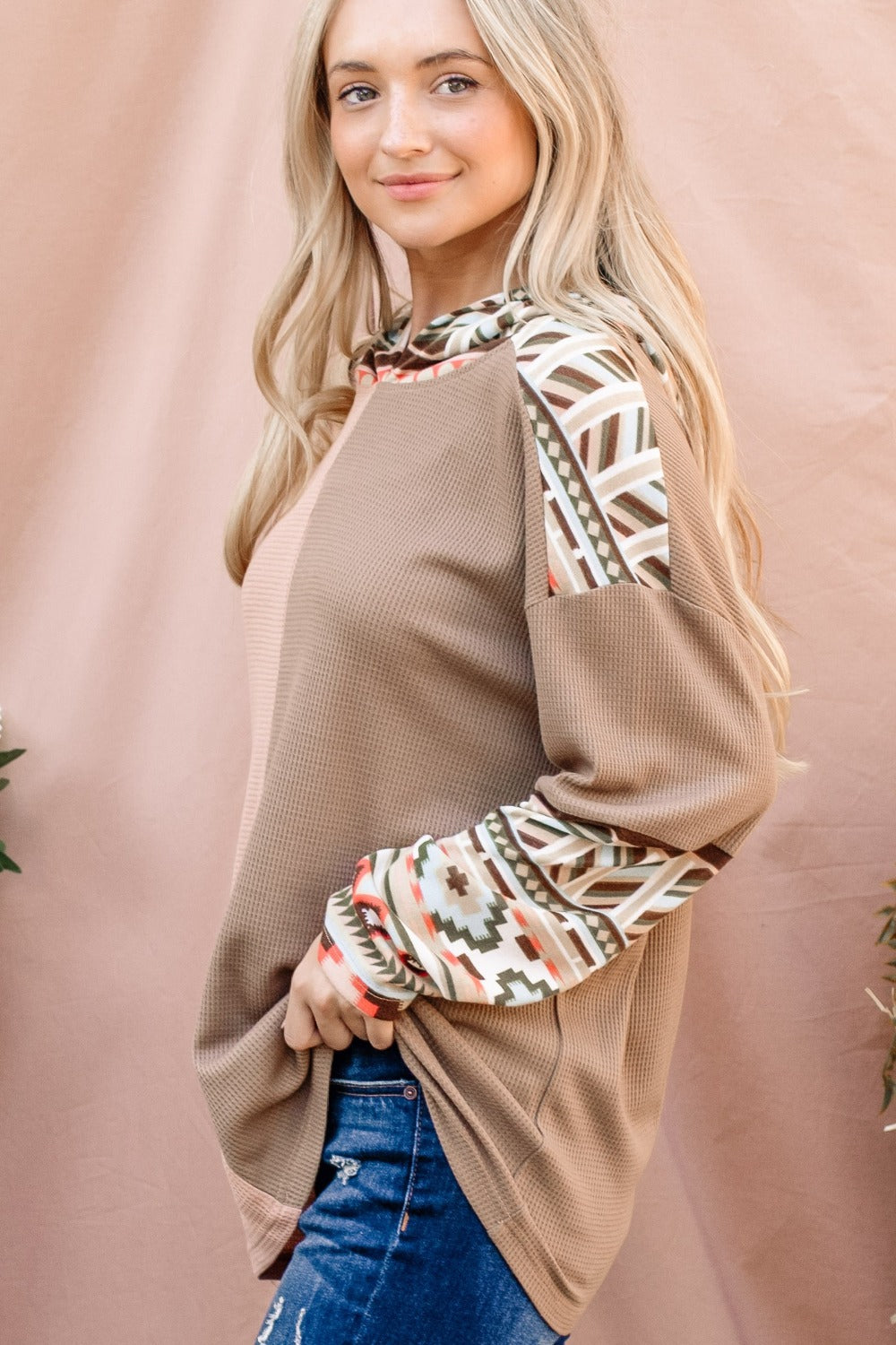 Western Aztec Print Hoodie Long Sleeve Pullover. The Printed Color Block Hooded Waffle Top has a fun, eye-catching element, while the hooded detail provides extra warmth and casual style. The waffle texture enhances the top’s comfort and visual interest, making it a versatile piece for relaxed, everyday wear. Apricot/tan