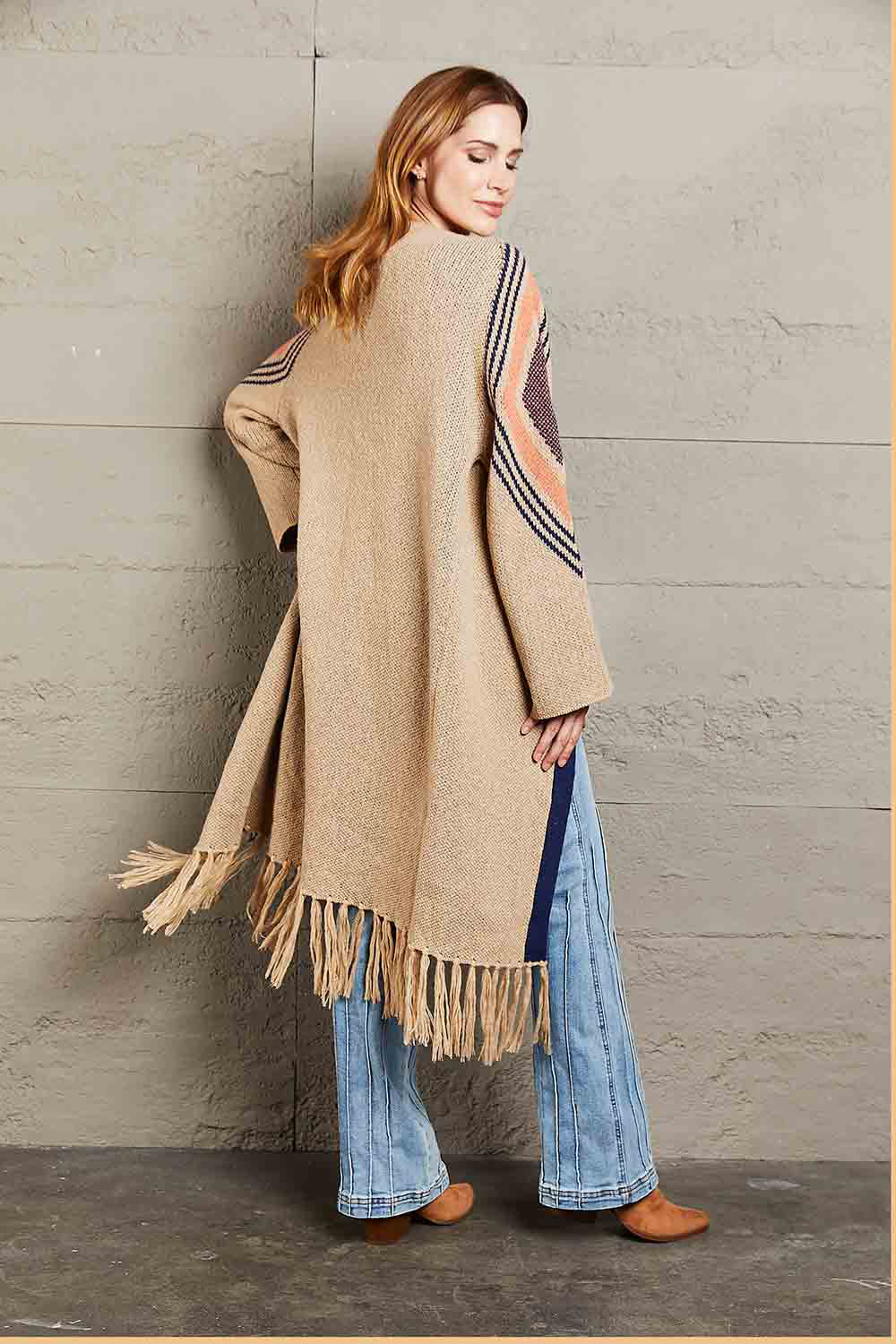 Long Fringe Cardigan- "Western Winds Boho Duster- A Layering MVP". Do you love the boho-western style? Do you love layers you can use in any season? You are in the right spot! Wrap yourself in comfort and style that feels as free as the open road. This open-front cardigan with its striking geometric accents and fringe detailing is the perfect mix of earthy charm and boho spirit. The perfect topper for every season – layer it, love it, and never look back.