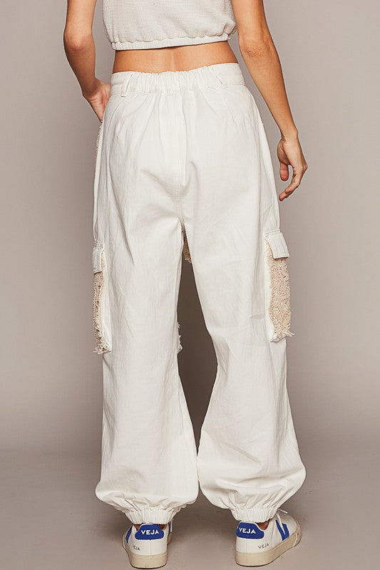 If you prefer a distinct touch to what you wear and you love the blend of feminine with a bit of edge, then these jogger jeans are meant for you! These distressed washed jeans feature a unique combination of crochet detailing and distressed elements, creating an eclectic touch to your wardrobe. Picture the ideal free-spirted look of a delicate and feminine contrast to the rugged distressed areas. These jeans are versatile and can be dressed up with a blouse and heels or dressed down with a casual t-shirt