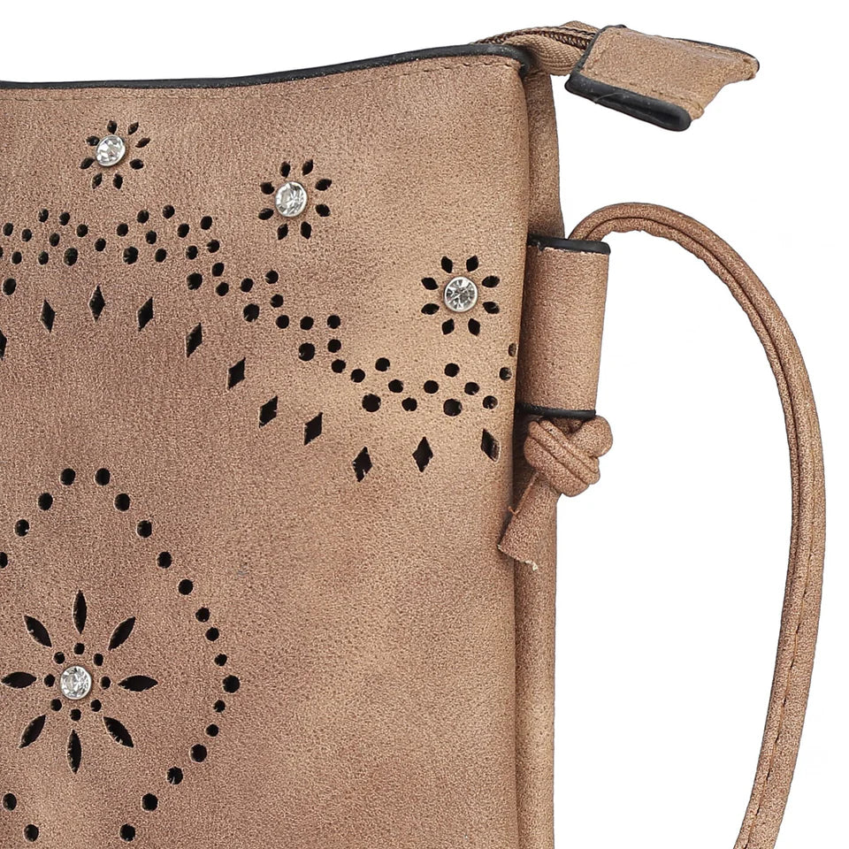 The Sustainable and Sleek Crossbody Bag works perfectly for days when much is not needed to carry to get through the day. Crafted with a supple soft Vegan leather material and gorgeous eyelet design. Roomy enough to fit a phone, keys, and a small wallet comfortably. This bag allows anyone to be hands-free and go about the day with ease and style.