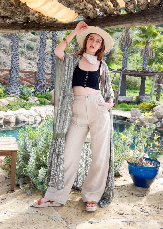 This sheer kimono is your ideal companion when you want to feel like you’re floating through life. Designed for the woman who loves to layer with ease and grace! This free flow Kimono stands out from others as it goes from a minimalist top and transitions beautifully into a rich paisley print as it flows toward the hem, creating a look that’s both modern and timeless. The oversized fit and mid-length sleeves add to the laid-back, breezy vibe, making it the ultimate piece for both lounging and living.