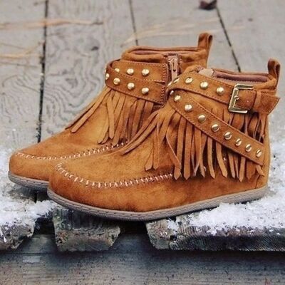 Step into the spirit of adventure with these Fringe Studded Suede Flat Boots. Designed for the free-spirited woman who craves comfort and style, these boots blend western ruggedness and bohemian flair. With soft, rich suede, fringed accents flowing with every step, bold rivets adorning the straps, these cowboy booties have a rebellious sparkle that are available in several earthy tones. Just right for a woman not afraid to make a statement.