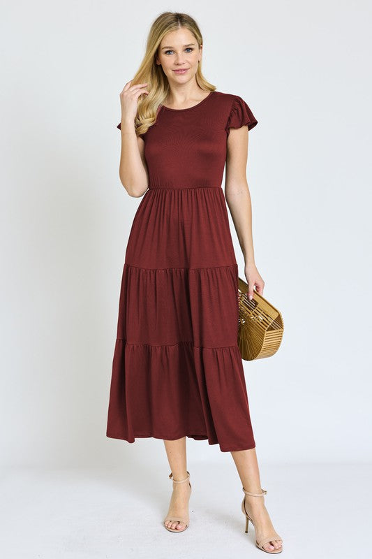 This Solid Flutter Sleeve Tiered Tea Length Dress was designed with you in mind!
Step into a thoughtfully designed dress to complement your curves and highlight your natural beauty. The soft, stretch fabric hugs in all the right places, offering all-day comfort taking you confidently from morning to night. Whether you are enjoying a garden party, or having a casual afternoon out, this dress has the versatility to be that go-to for many types of events.
