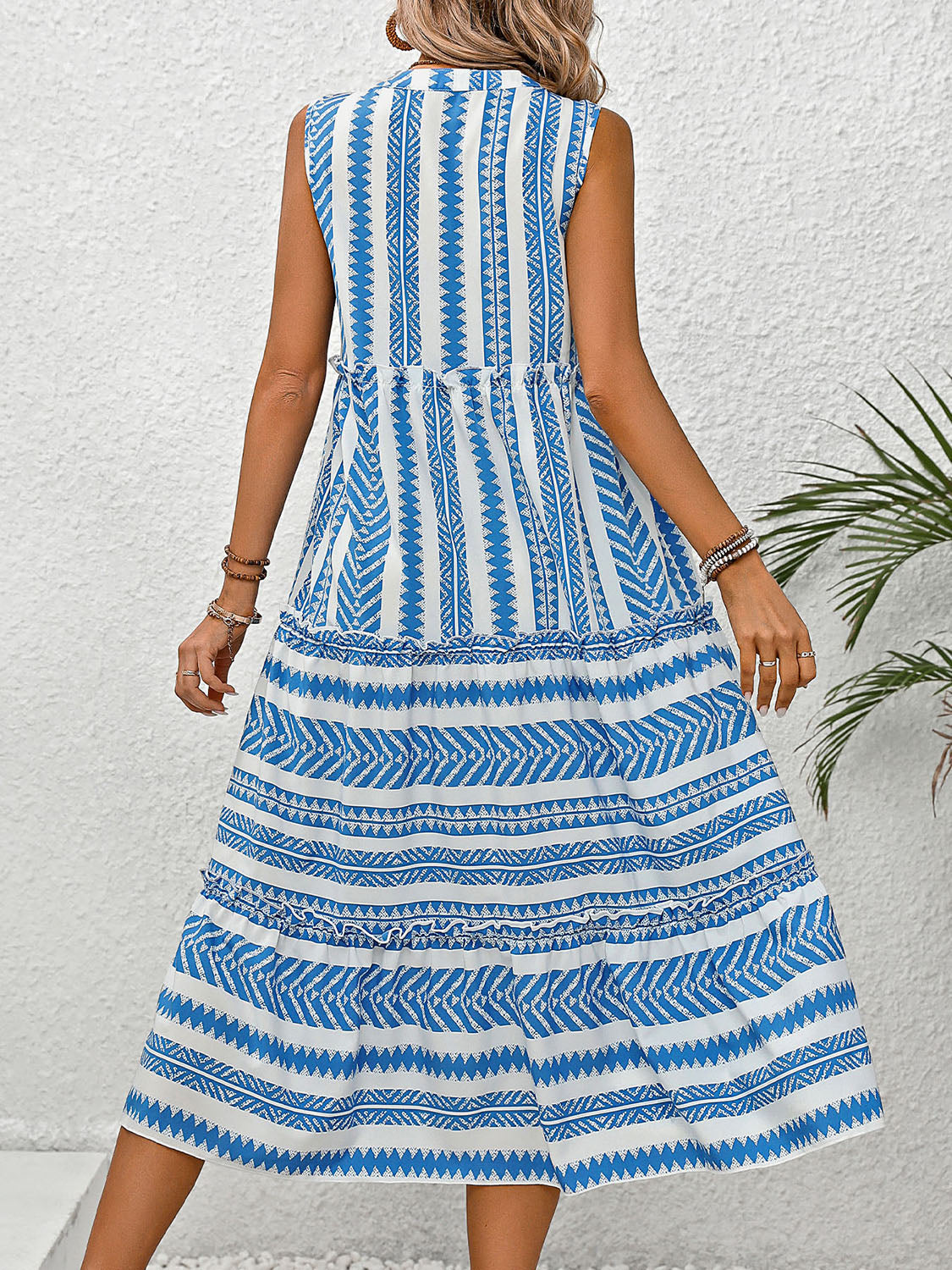 Notched Sleeveless Dress. Are you going somewhere warm and sunny this winter? Need a vacation dress? This dress has a fun design, some frill, is flowy and breathable. Imagine walking down the beach, checking out the attractions, or sipping on your favorite drink at the outdoor bar in this "vacay" dress.