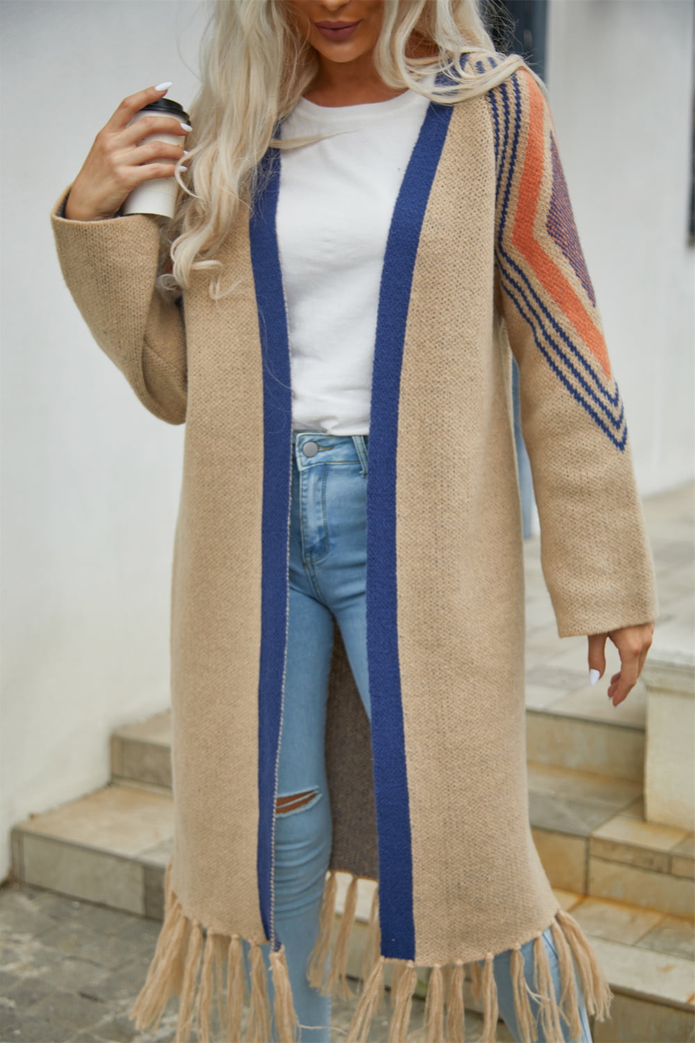 Long Fringe Cardigan- "Western Winds Boho Duster- A Layering MVP". Do you love the boho-western style? Do you love layers you can use in any season? You are in the right spot! Wrap yourself in comfort and style that feels as free as the open road. This open-front cardigan with its striking geometric accents and fringe detailing is the perfect mix of earthy charm and boho spirit. The perfect topper for every season – layer it, love it, and never look back.