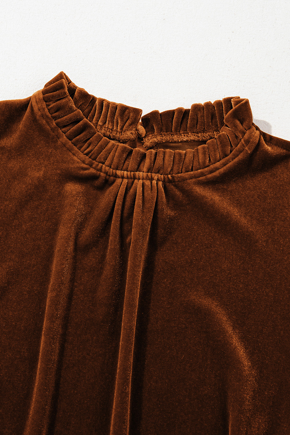 his beautiful chestnut mock neck top dials up your boho style with plush velvet fabric and romantic vibes. The soft, lustrous fabric adds a touch of sophistication, making it perfect for both casual outings and dressed-up occasions.