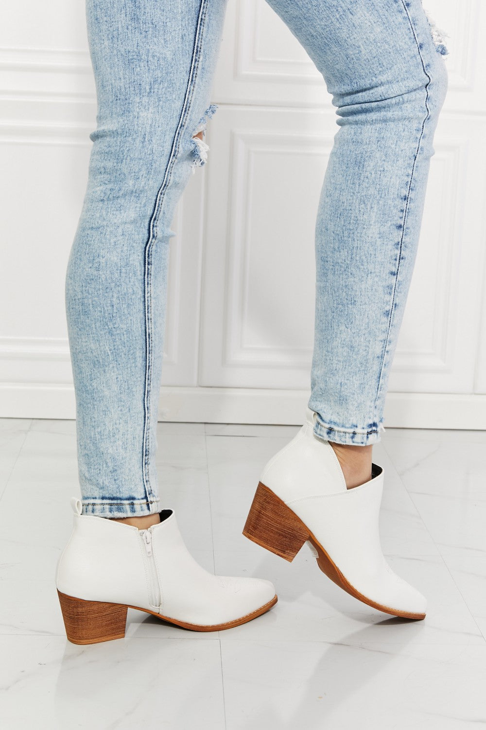 We've fallen in love with these crossover cowboy booties, with 2.5-inch stacked heel in white. These stunning crossover cowboy booties are designed to deliver both style and comfort. They feature a pointed toe, bold stitching, and a block heel for effortless all-day wear. They transition well from season to season. The embroidered design provides a classic touch and these cowboy booties pair well with distressed jeans or your favorite dresses.