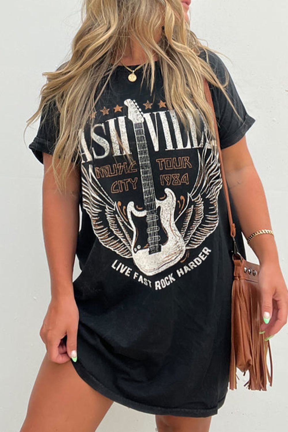 As the weather warms up this western music graphic t-shirt dress is going to be a fun and effortless pullover to pair with your favorite boots and accessories to get out the door! This short sleeve, black t-shirt dress can be worn out during the day running errands, meeting with friends, and then going to a festival or concert with a layer at night. Need a fringe handbag or a layer to complete the style? Just check out our handbag section and the layer/ outdoor section to complete the outfit.