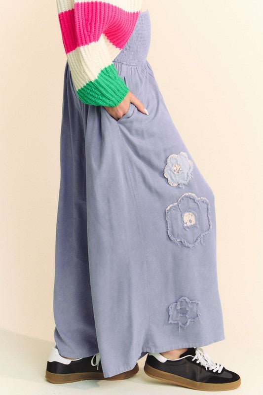The Smocked Waist Flower Patch Wide Leg Pants offer a carefree, free-spirited vibe.
Here we go! Wide Leg Pant s, check, smocked, flattering smocked fit, check, flower patches that bring the charm and whimsy, check, effortless style for any laid-back day, check! Ideal for any boho style wardrobe.