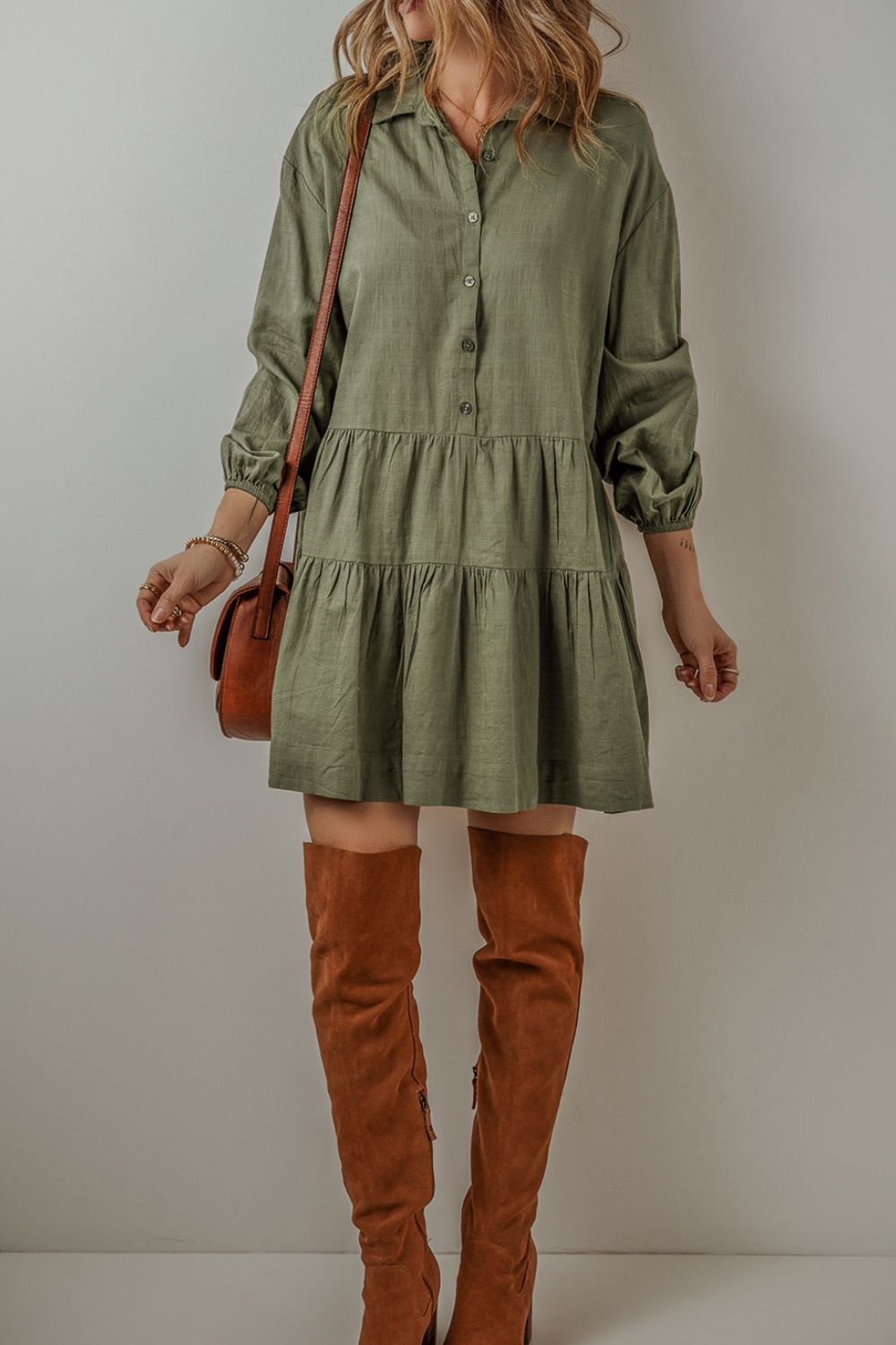 Feel the way this dress moves, (loose and flowy) and you will feel ready to start your day! The tiered style and army green creates a flattering dress that is equal parts free-spirited and laid-back western. The textured ruching along the seams creates a subtle, rippling effect that adds a touch of character to the flowy silhouette. Balloon sleeves bring a playful, whimsical vibe. Designed for comfort and breathability, this dress is perfect for those sunny afternoons or casual get-togethers.