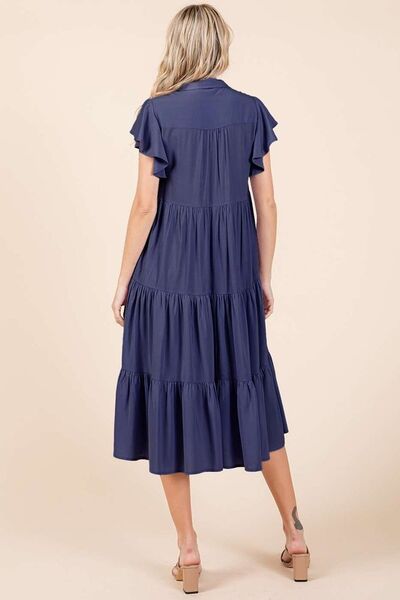 A ruffle sleeve, collared V-neck, tiered midi dress provides a simple feminine style. The tiered design creates a layered and textured look, adding dimension and flow. The midi length falls below the knee, making it versatile for both casual and more dressed-up occasions. Whether you're enjoying a sunny day in the park or headed to a rooftop dinner, this dress pairs effortlessly with sandals, boots, or layered jewelry for a carefree yet stylish vibe. Its timeless simplicity makes it a piece you