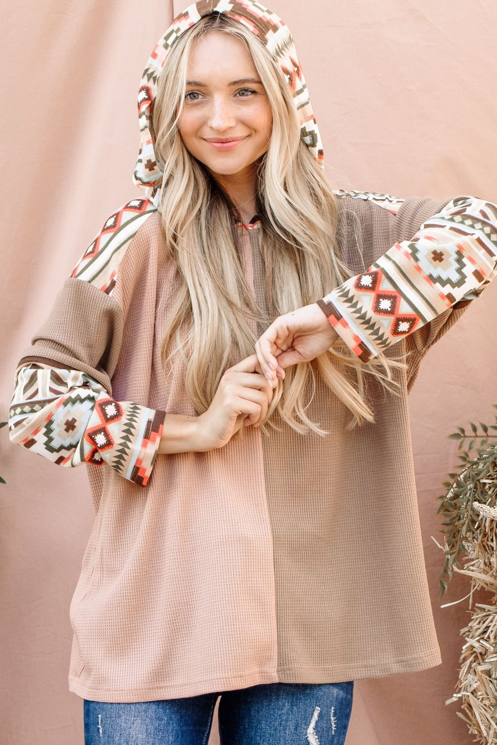 Western Aztec Print Hoodie Long Sleeve Pullover. The Printed Color Block Hooded Waffle Top has a fun, eye-catching element, while the hooded detail provides extra warmth and casual style. The waffle texture enhances the top’s comfort and visual interest, making it a versatile piece for relaxed, everyday wear. Apricot/tan