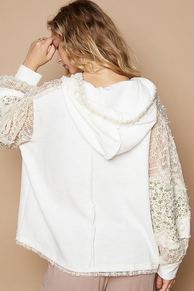 Whimsical Star Patch Hooded Shirt - A Feminine Twist on Rebel Style - Ivory Multi. Does it feel sexy to be edgy and feminine at the same time? You got it! This star print adds some whimsy, and the lace contrast gives a delicate and elegant touch to the design. We love the mixed textures, making this top perfect for both casual and dressed-up looks.
