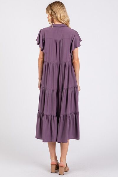A ruffle sleeve, collared V-neck, tiered midi dress provides a simple feminine style. The tiered design creates a layered and textured look, adding dimension and flow. The midi length falls below the knee, making it versatile for both casual and more dressed-up occasions. Whether you're enjoying a sunny day in the park or headed to a rooftop dinner, this dress pairs effortlessly with sandals, boots, or layered jewelry for a carefree yet stylish vibe.