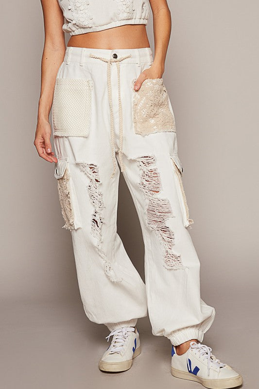 If you prefer a distinct touch to what you wear and you love the blend of feminine with a bit of edge, then these jogger jeans are meant for you! These distressed washed jeans feature a unique combination of crochet detailing and distressed elements, creating an eclectic touch to your wardrobe. Picture the ideal free-spirted look of a delicate and feminine contrast to the rugged distressed areas. These jeans are versatile and can be dressed up with a blouse and heels or dressed down with a casual t-shirt 